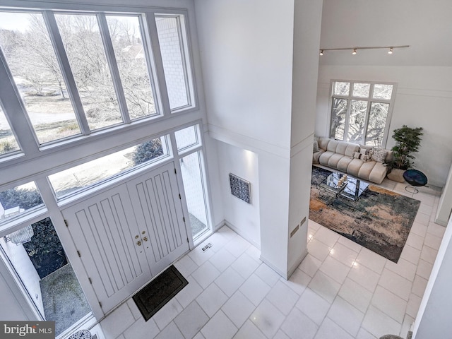 entrance foyer featuring visible vents and track lighting