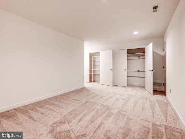 unfurnished bedroom featuring recessed lighting, carpet flooring, visible vents, and baseboards