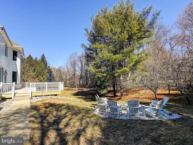 view of yard featuring a fire pit and a deck