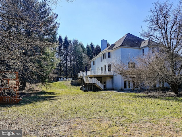 view of yard with a deck and stairs