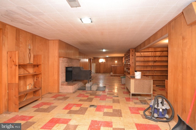 unfurnished living room with wood walls