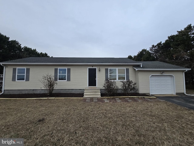 view of front of house with a front lawn and a garage