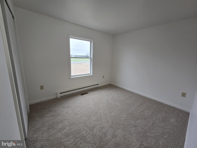 empty room with carpet floors and baseboard heating