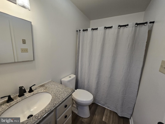 bathroom featuring hardwood / wood-style flooring, vanity, and toilet