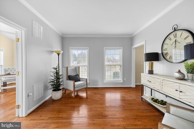 sitting room featuring crown molding and hardwood / wood-style floors