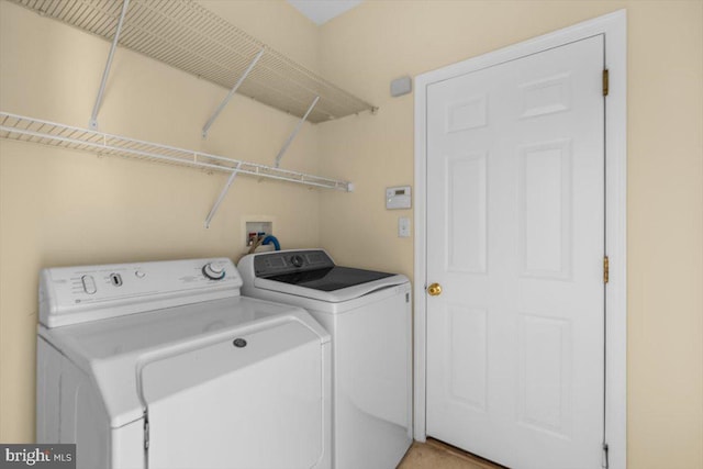 clothes washing area with separate washer and dryer