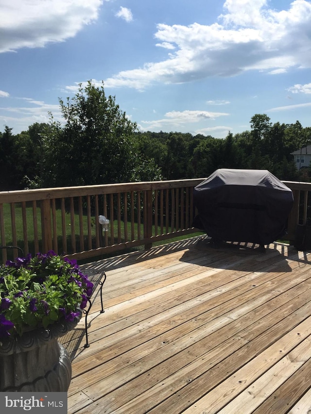 wooden terrace featuring grilling area