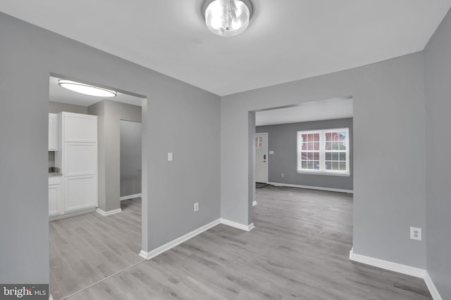 unfurnished room with light wood-type flooring