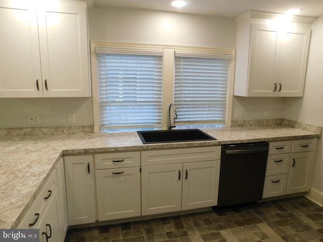 kitchen featuring dishwasher, white cabinetry, and sink