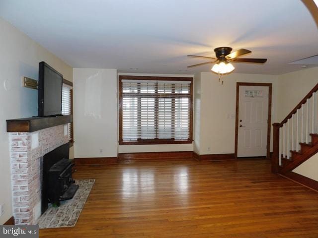 unfurnished living room featuring wood-type flooring and ceiling fan