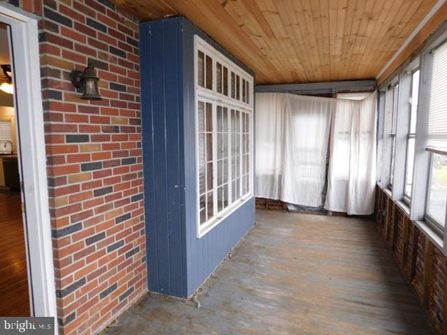 unfurnished sunroom with wood ceiling