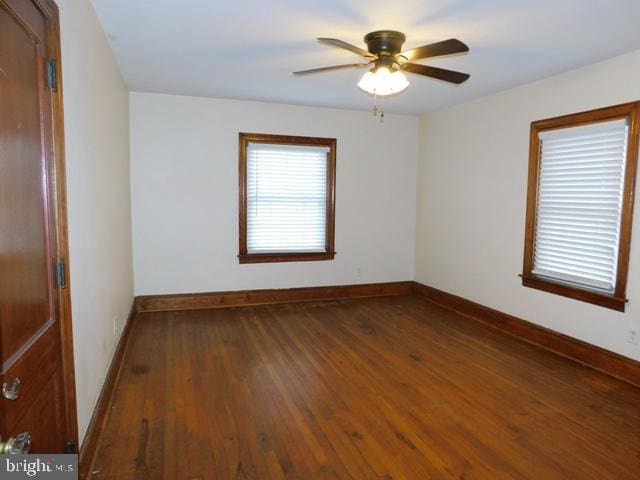 spare room featuring ceiling fan and dark hardwood / wood-style flooring