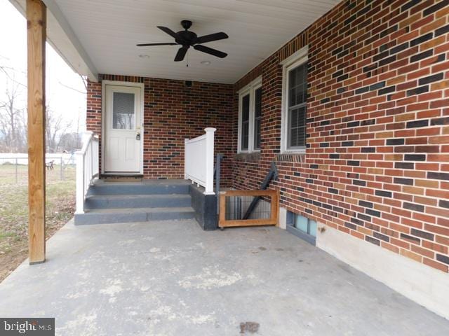 view of exterior entry featuring ceiling fan