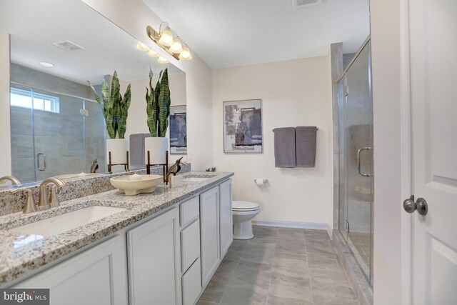 bathroom with tile patterned floors, vanity, toilet, and walk in shower