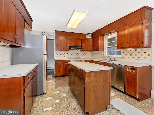 kitchen with backsplash, a center island, sink, and stainless steel appliances