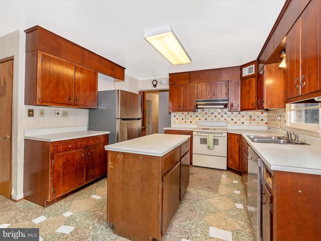 kitchen with tasteful backsplash, sink, a center island, and appliances with stainless steel finishes