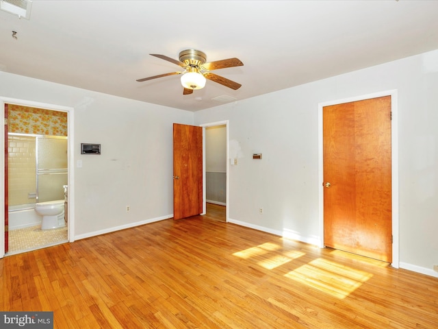 unfurnished bedroom featuring ensuite bath, ceiling fan, and light wood-type flooring