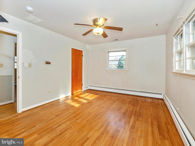 unfurnished room with ceiling fan, light wood-type flooring, and a baseboard heating unit