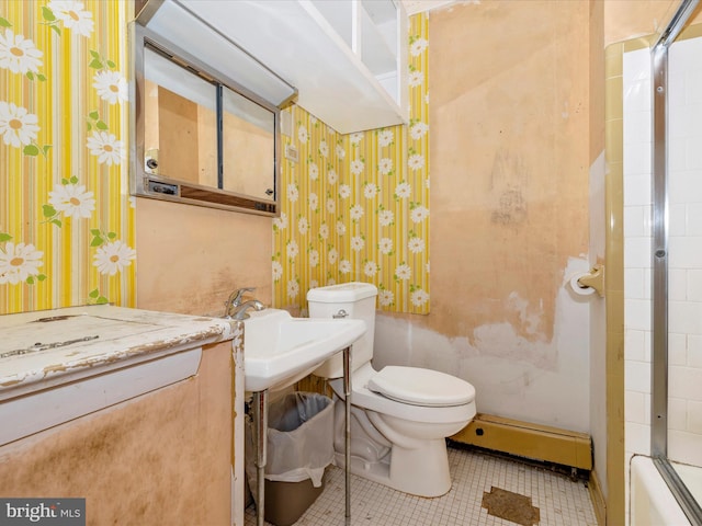 bathroom with toilet and a baseboard heating unit