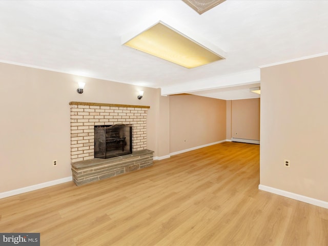 unfurnished living room with a brick fireplace, crown molding, light hardwood / wood-style flooring, and a baseboard heating unit