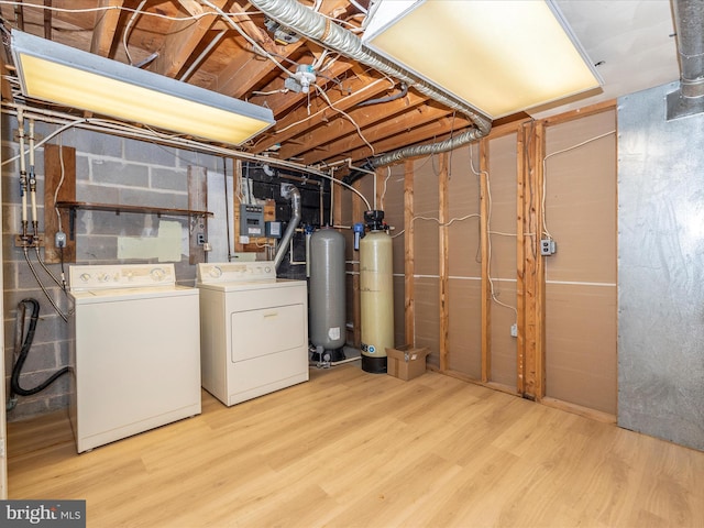 basement featuring light hardwood / wood-style flooring and washing machine and clothes dryer