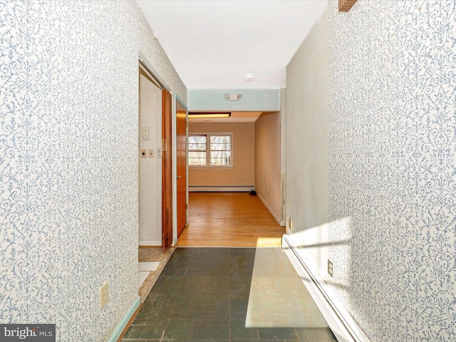 hall featuring dark wood-type flooring and a baseboard heating unit