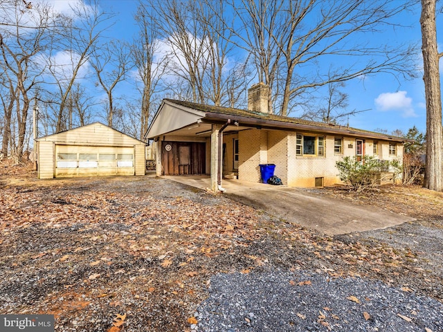 view of front facade featuring an outbuilding, a garage, and a carport