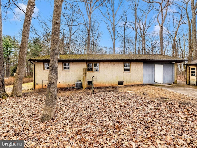 rear view of house with central AC unit