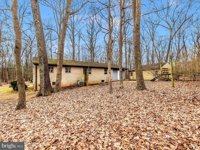 back of property featuring central AC unit