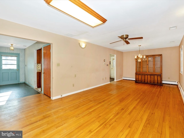 unfurnished living room featuring ceiling fan with notable chandelier, light hardwood / wood-style floors, and a baseboard heating unit