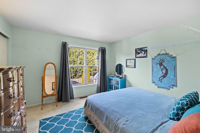 bedroom featuring light carpet