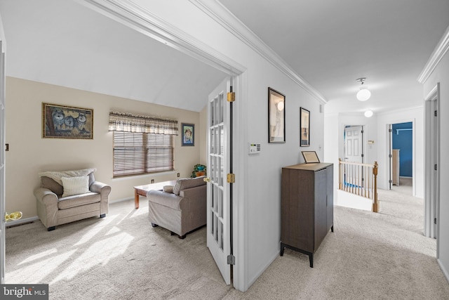 hall featuring light carpet and ornamental molding