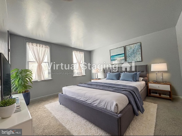 bedroom featuring carpet and baseboards