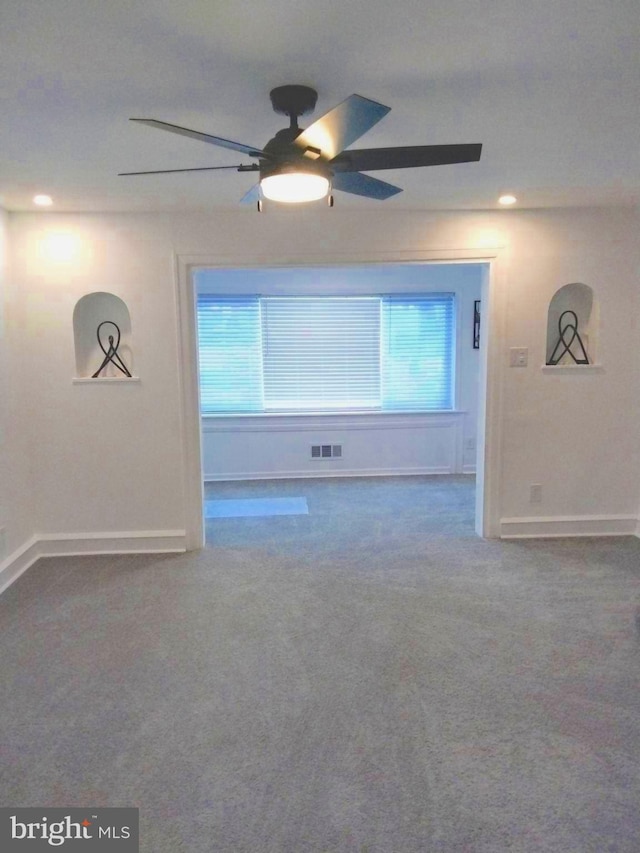 empty room featuring ceiling fan and carpet floors