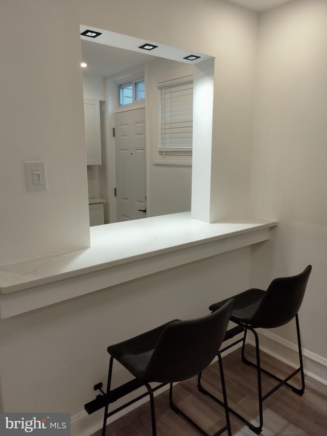 interior space featuring wood-type flooring and built in desk