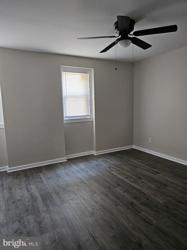 empty room featuring ceiling fan and dark hardwood / wood-style flooring