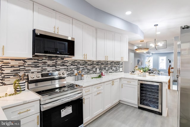 kitchen featuring kitchen peninsula, white cabinetry, stainless steel appliances, and wine cooler