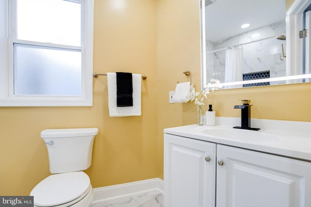 bathroom featuring vanity, toilet, and curtained shower