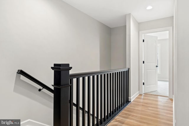 hallway with hardwood / wood-style floors