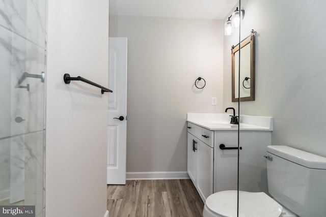 bathroom with vanity, toilet, and wood-type flooring