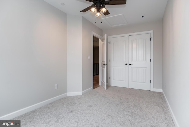 unfurnished bedroom featuring light colored carpet, a closet, and ceiling fan