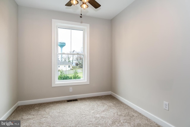 carpeted empty room featuring ceiling fan