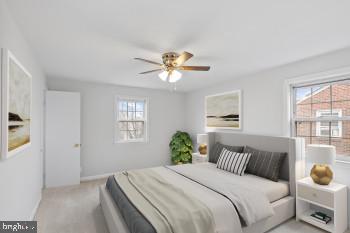 carpeted bedroom featuring ceiling fan