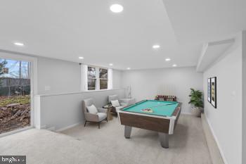 rec room with light carpet, a healthy amount of sunlight, and pool table