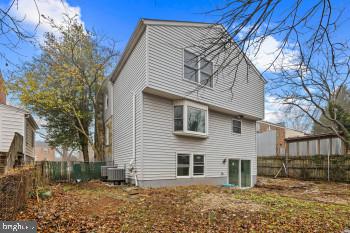 rear view of house featuring central AC