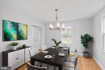 dining area featuring a notable chandelier and light hardwood / wood-style floors