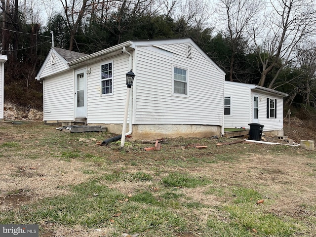 view of side of home with a lawn