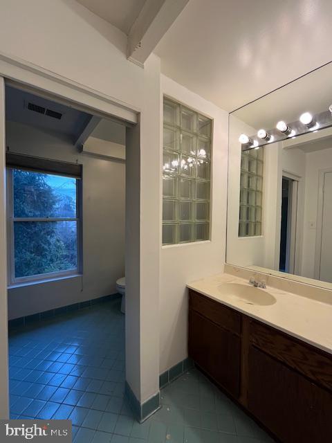 bathroom featuring tile patterned flooring, vanity, and toilet