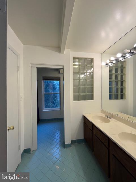 bathroom with tile patterned floors and vanity