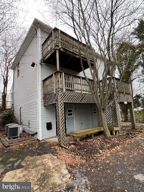 back of house with a balcony and cooling unit